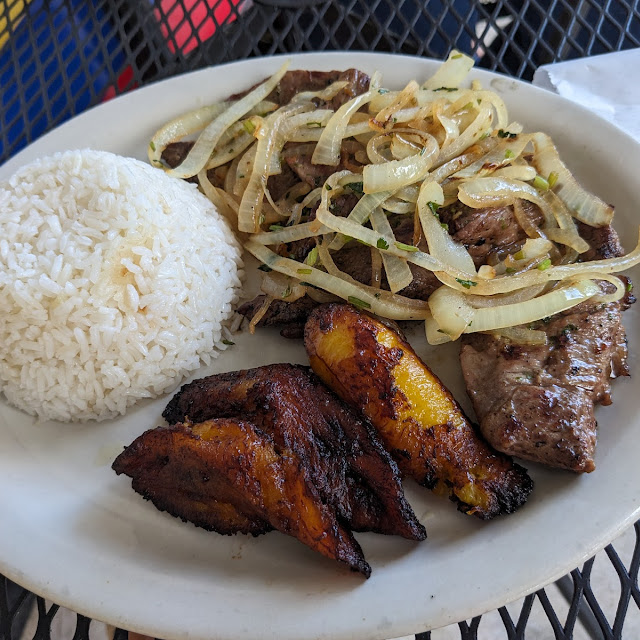 Two Eggs over Easy and Carne Ensebollada with Tostones and Rice