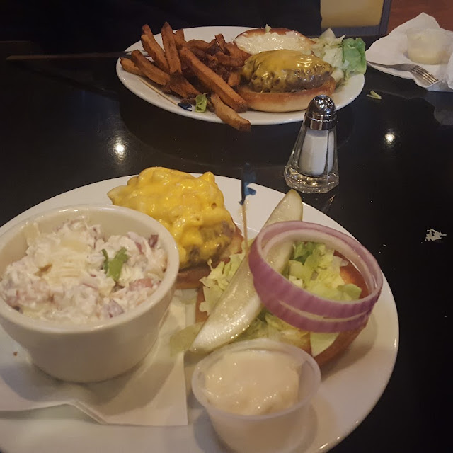 Mac N Cheese Burger and Potatoe Salad and a Classic Cheeseburger with Handcut Fries