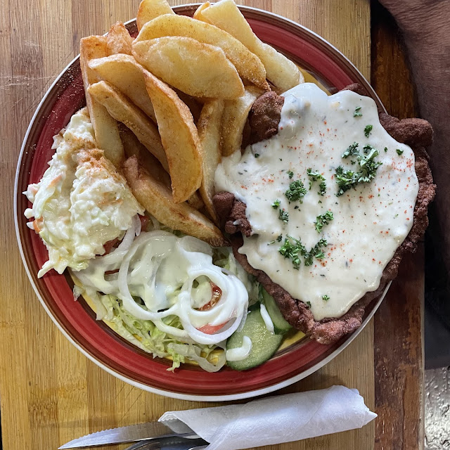 Crumbed Pork Chop and Mushroom Sauce with Salad and Wedges