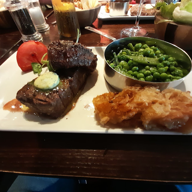 Black Angus Fillet Mignon 10oz Steak with Sauteed Greens Tomato Onion Loaf Three Peppercorn Dressing