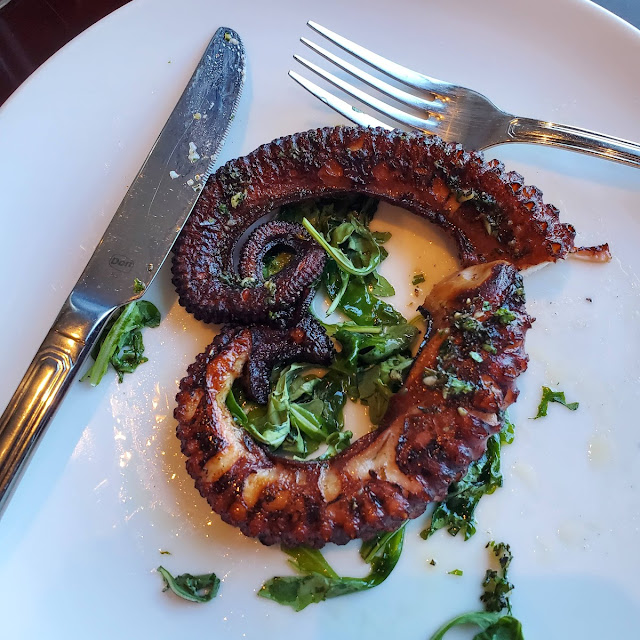 Grilled Octopus on a Bed of Arugula Topped with Garlic Herb Oil