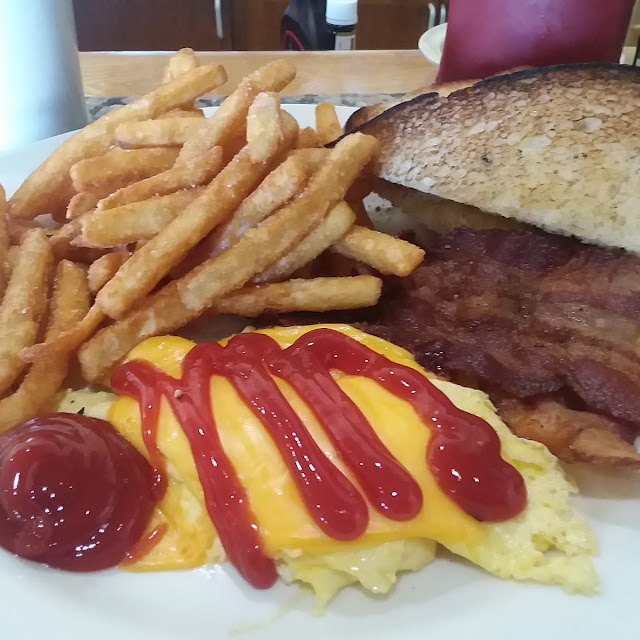Scrambled Eggs and Corned Beef Hash with French Fries and a Bagel
